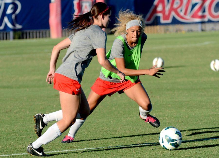 Arizona junior defensive midfielder Alexa Montgomery (20) puts pressure on a fellow team in a scrimmage during practice on Tuesday at Murphey Field at Mulcahy Soccer Stadium. Montgomery and the Wildcats face No. 1 UCLA on the road on Friday.