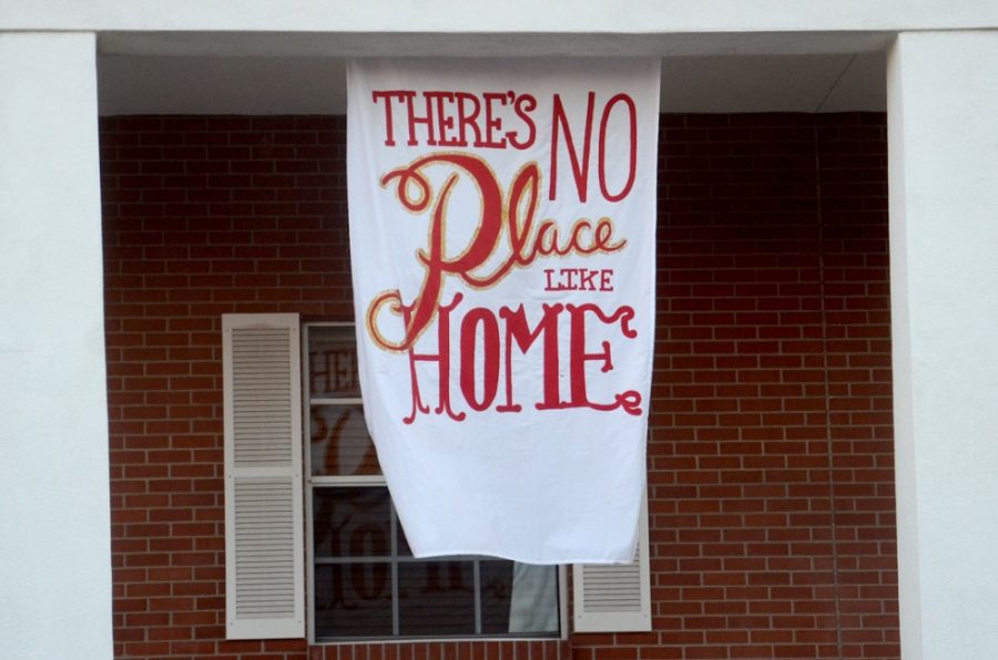 Chi Omega hangs a Homecoming flag on its house on Thursday for Homecoming weekend. Greek Life celebrates 100 years of Homecoming traditions.