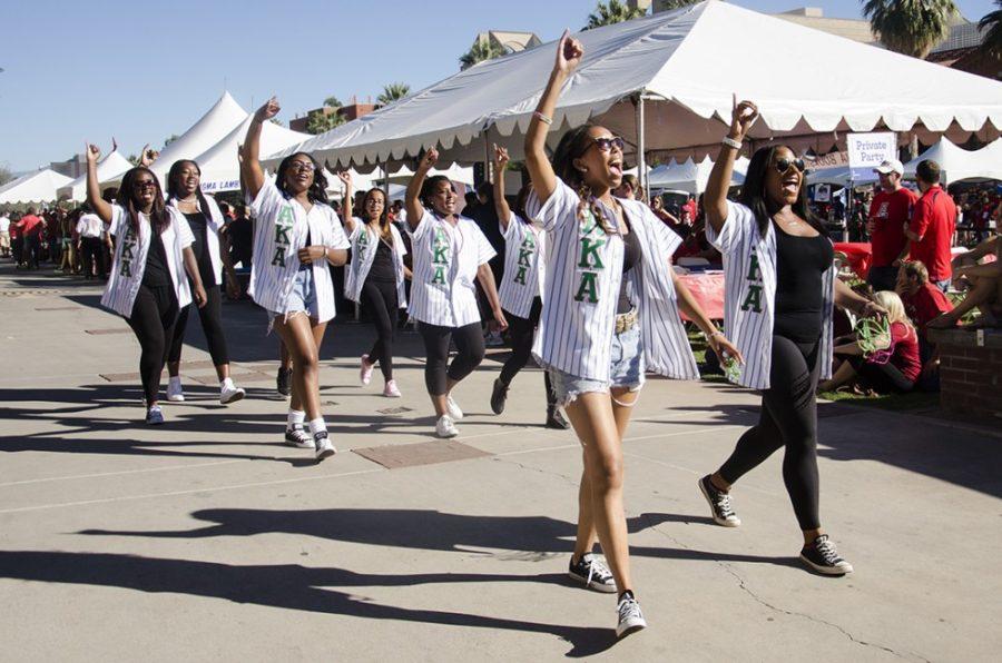 Sorority members from the iota Tau chapter of Alpha Kappa Alpha Sorority cheer as they walk through the UAs 100th Homecoming Parade on Saturday. 
