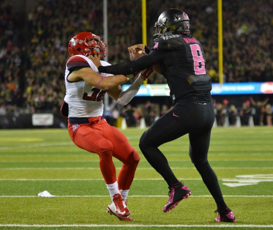 <p></p><p>Arizona safety Jared Tevis (38) tries to take down Oregon quarterback Marcus Mariota (8) during Arizona's 31-24 win at Autzen Stadium. The Wildcats and Ducks will face each other in the Pac-12 Conference Championship Game this Friday.</p>