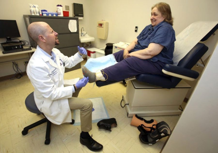 <p>Courtesy of David G. Armstrong </p><p>David G. Armstrong, director of  Southern Arizona Limb Salvage Alliance and a professor of surgery at the  UA, in the SALSA Clinic with patient Pearl Badman in 2013. SALSA  researchers and clinicians have developed Smart Socks, which will alert  patients' smart phones when ulcers are about to develop.</p>