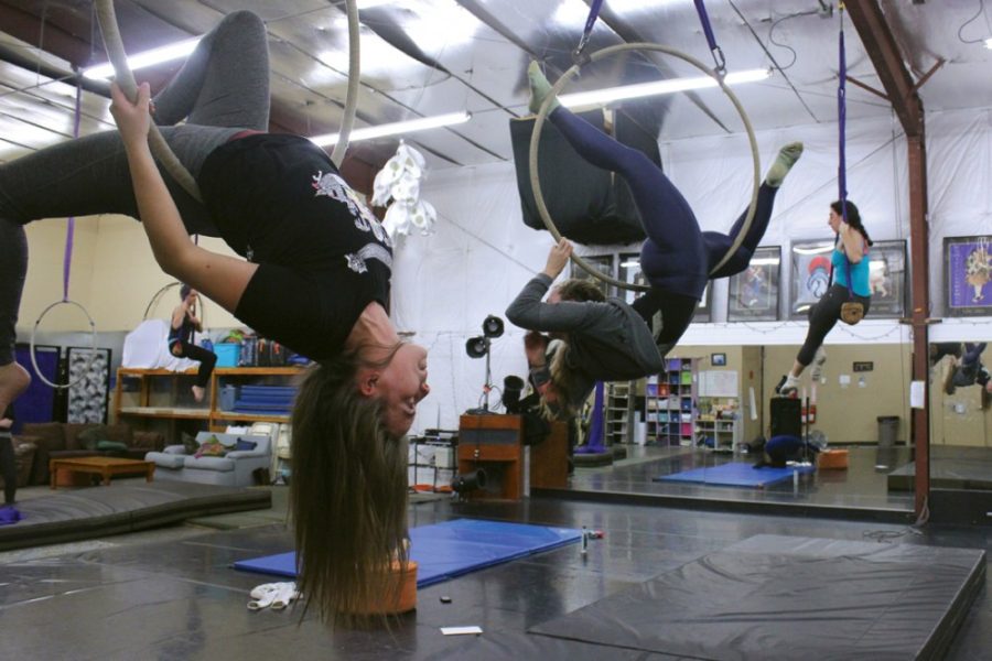 Savannah Douglas / The Daily Wildcat 

Intermediate aerial circus student Laura Burghardt practices with the Tucson Circus Company under the lead of Annie Mielke on Thursday. Burghardt has been  with the company for two years. 