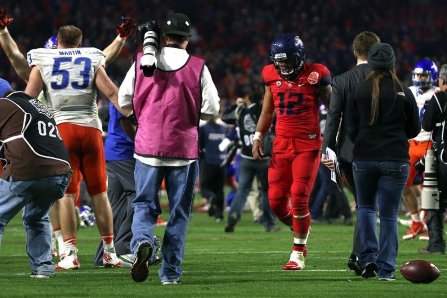 Arizona quarterback Anu Solomon (12) defeatedly walks off the field after Arizonas 38-30 loss against Boise State in the Vizio Fiesta Bowl Game in Glendale, Ariz. at University of Phoenix Stadium on Wednesday.