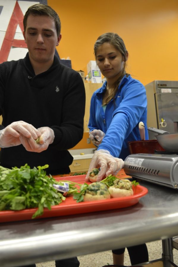 Physiology freshman Hayden Pastorini ,left, and Veterinary Science freshman Jordan Sanchez, right, make spinach and asiago stuffed mushrooms on Wednesday, Jan. 27 at  the Outdoor Adventures building at the Campus Recreation Center.