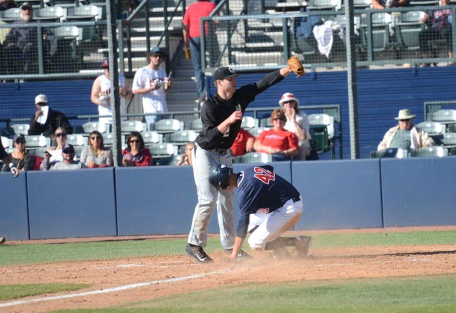 Arizona baseball outfielder Jared Oliva (42) slides safely into home as Oakland pitcher Nate Green (32) attempts to tag him out during Arizonas 13-0 victory over Oakland on Wednesday at Hi Corbett Field. The Wildcats won 13-0 on Wednesday to complete the two-game sweep against Oakland.