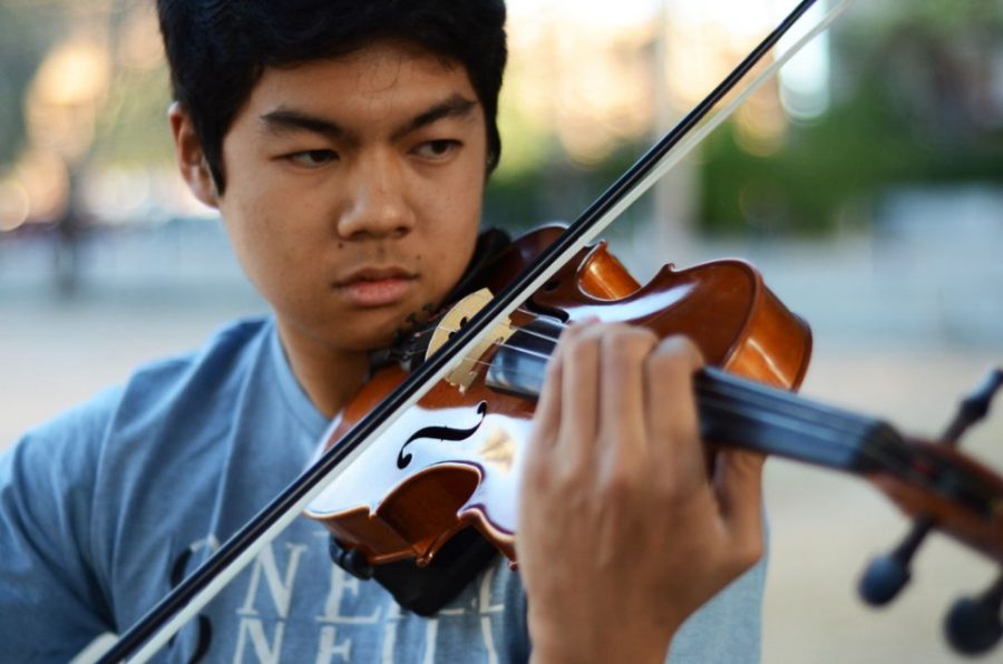 Pre-physiology freshman Michael Manaloto plays a Bach Partita outside of Park Student Union on Thursday. Manaloto will be performing an electro-pop mash-up on his violin at the Honors Talent Show on Friday at 6 p.m.