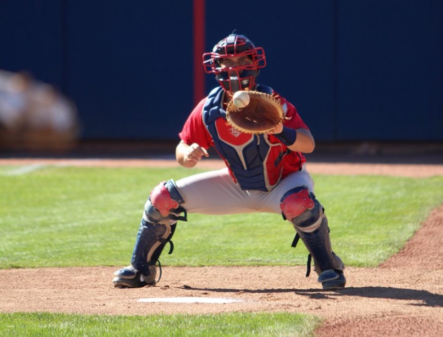 Arizona baseball catcher Handsome Monica (12) catches during practice at Hi Corbett Field on Tuesday. Monica is among several newcomers who could contribute to the Wildcats this season.