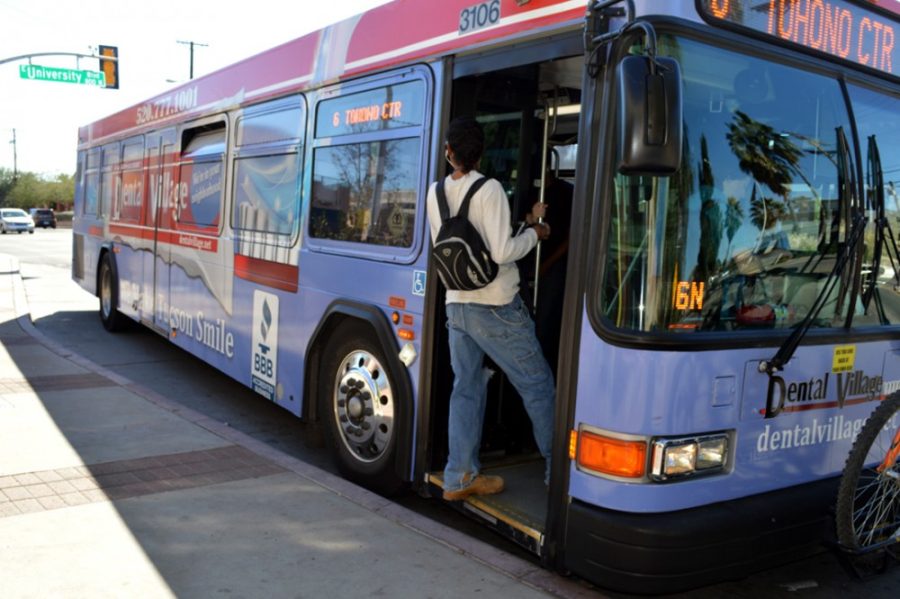 A Tucson resident boards the northbound Sun Tran at the intersection of University Boulevard and Euclid Avenue on Friday.