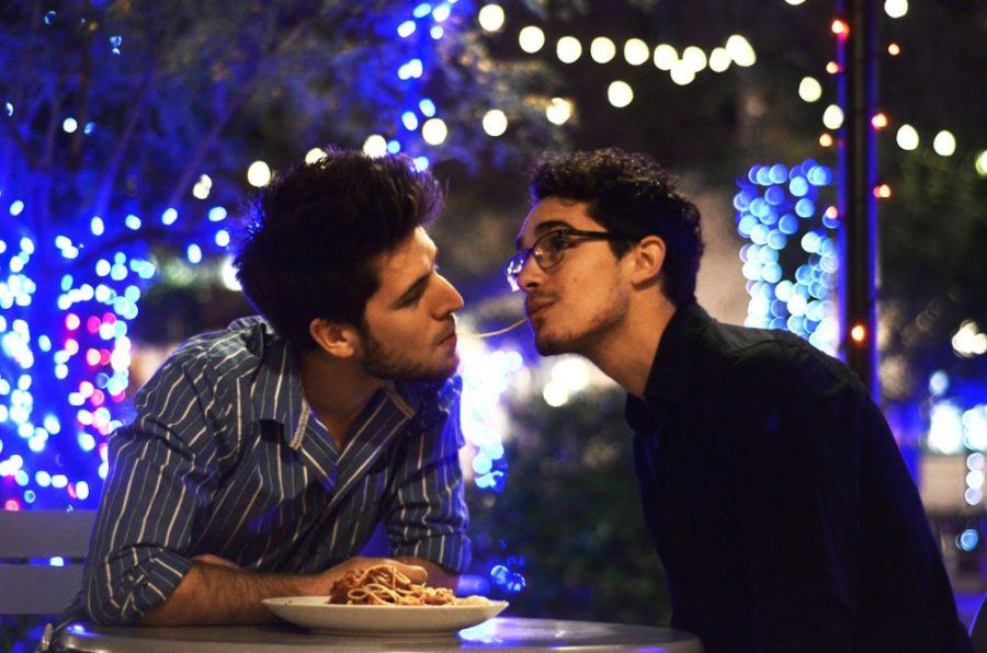 Kevin Snavley, left, and Ian Martella, right, reenact the beloved Lady and the Tramp scene in Geronimo Plaza on Thursday.