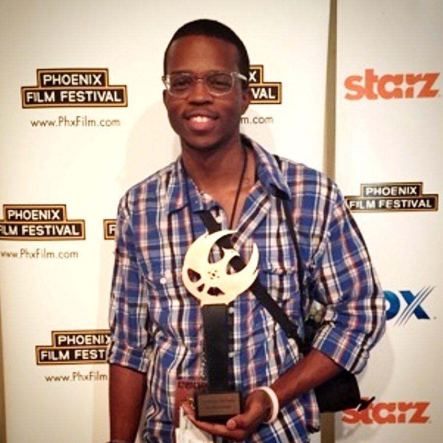 Courtesy of Darious BrittDarious Britt poses with the award won by his film Unsound at the Phoenix Film Festival on Sunday. Unsound won Best Arizona Film for 2015. Britt is a UA alumnus who recently graduated and based his film on real-life experiences.