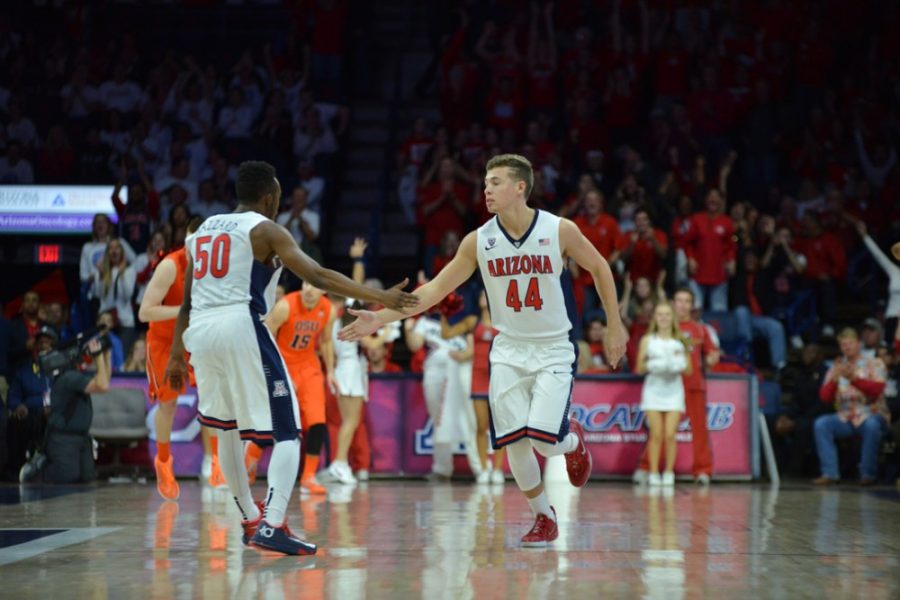 Arizona guards Jacob Hazzard (50) and Trey Mason (44) slap hands during  Arizonas 57-34 victory over Oregon State on Jan. 30 in McKale Center.  Hazzard and Mason are walk-ons and have a bigger role on the team than  the average fan might think.