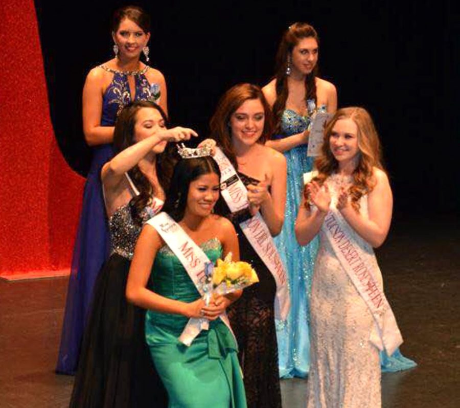 Courtesy of Patricia DuenasMiss Tucson Desert Rose Patricia Duenas is crowned by former Miss Tucson Desert Rose Rachel Dyckman on Jan. 17 at the Pima Community College Center for the Arts. Duenas is a pre-nursing sophomore and a veteran of pageantry competition.