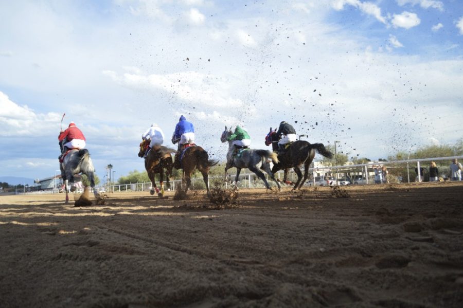 Courtesy of Jesus Barerra / Rillito Park Race TrackJockies rush out of the gates to begin the last race of the day at the Rillito River Race Track. The racetrack was almost closed an turned into a strip mall in the past.