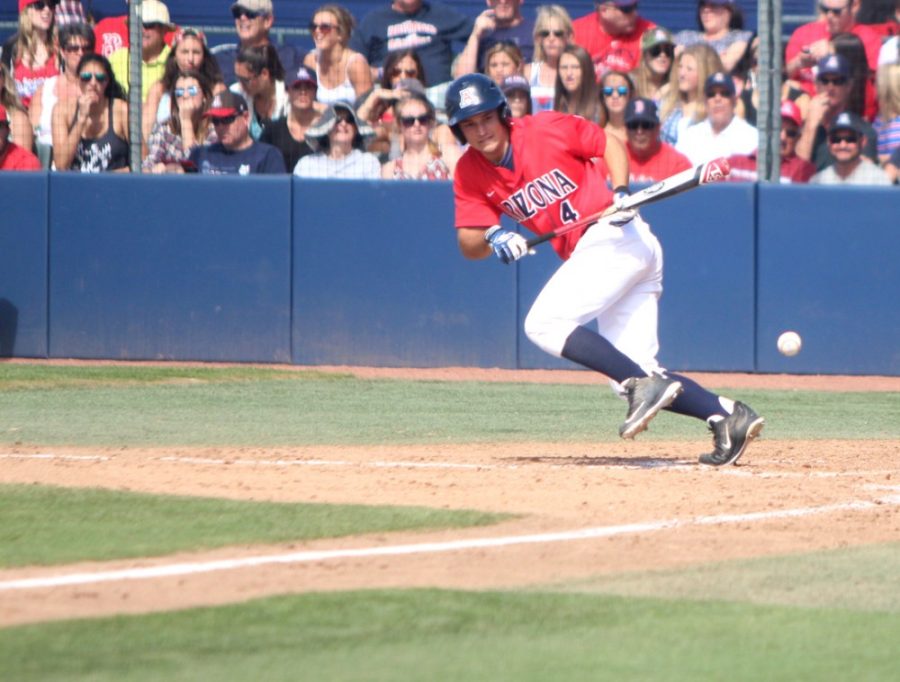 Arizona baseball outfielder Justin Behnke (4) bunts during Arizonas 6-4 extra innings loss against Rice on Feb. 22 at Hi Corbett Field. Behnke and the Wildcats take on New Mexico State for a two-game series on Tuesday and Wednesday.
