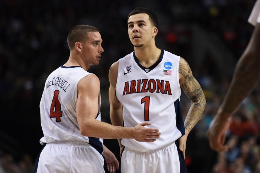 Arizona guards TJ McConnell (4) and Gabe York (1) exchange briefs words before Yorks free throw attempt during Arizonas 73-58 win against Ohio State in the second round of the NCAA Tournament in the Moda Center in Portland, Ore. on Saturday.