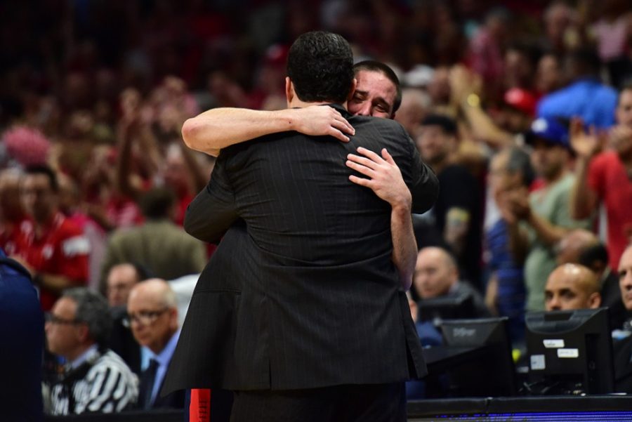 Arizona guard TJ McConnell (4) embraces coach Sean Miller as he walks off the court for the last time as a member of the Arizona mens basketball team after Arizonas crushing 85-78 loss to Wisconsin in the Elite Eight of the NCAA Tournament in the Staples Center in Los Angeles, Calif. on Saturday night.