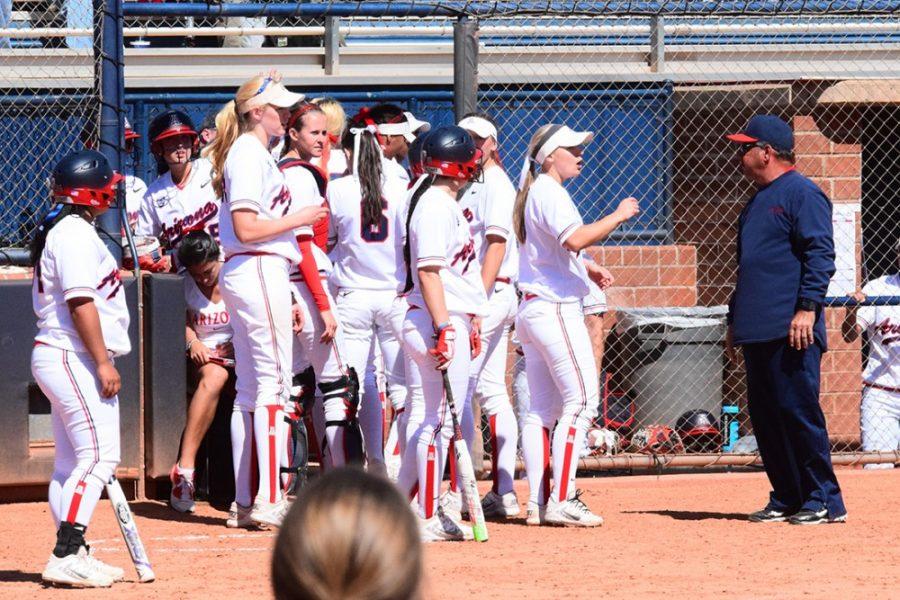 Arizona softball coach Mike Candrea speaks with his team towards the end of its 8-3 win against UNLV at Hillenbrand Stadium on March 4. The Wildcats look to maintain their momentum against ASU after making progress following a rough patch in their season.
