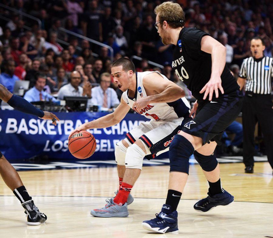 Arizona guard TJ McConnell (4) tries to navigate around Xavier center Matt Stainbrook (40) during Arizonas 68-60 win against Xavier in the Sweet Sixteen of the NCAA Tournament in the Staples Center in Los Angeles, Calif. on Thursday night.