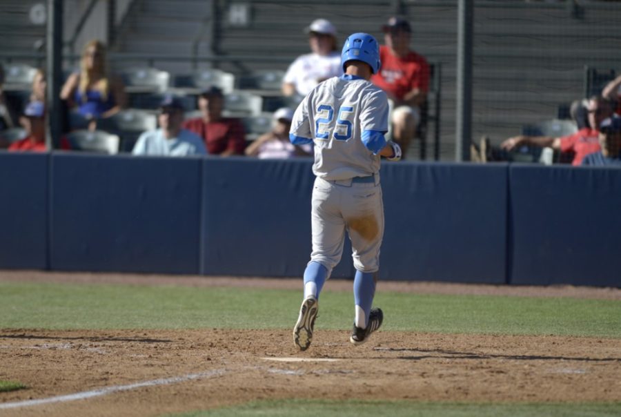 File Photo / The Daily WildcatUCLA baseball infielder Chris Keck (25) runs home during Arizonas 6-5 win against UCLA at Hi Corbett Field on April 13, 2014. The Bruins have seized the top rankings in the conference over USC.