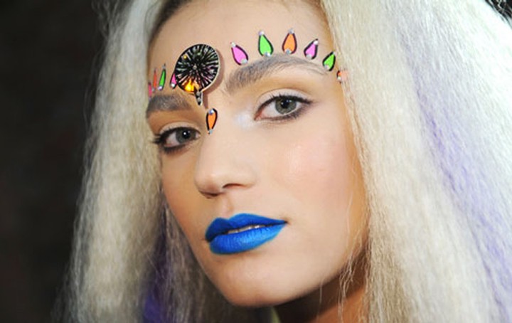 Courtesy of Ambivalently YoursA blue lip-sticked woman with a bindi poses for the camera. Bindis, along with henna tattoos and dreadlocks, have become controversial parts of festival-going outfits, bringing up conversations of cultural insensitivity and appropriation.