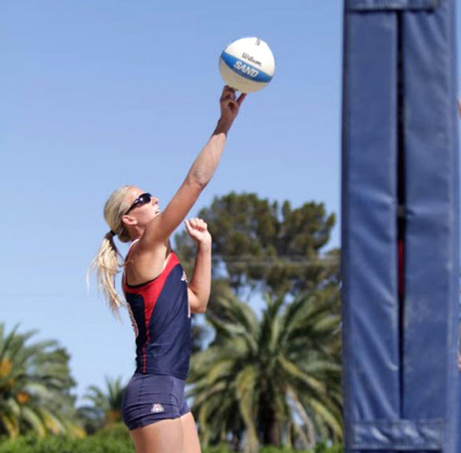 Arizona sand volleyball redshirt senior Kaitlyn Leary tips the ball over the net during Arizonas 5-0 victory over Cal State Northridge on Saturday at Jimenez Field. Leary has taken on a leadership role for the Wildcats this season.