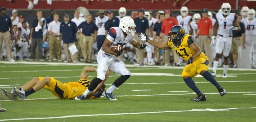 Arizona football wide receiver Austin Hill (29) looks to avoid defenders during Arizonas 49-45 victory over California on Sep. 20, 2014 at Arizona Stadium. Hill is among a handful of Wildcats who will likely go undrafted during the NFL Draft.