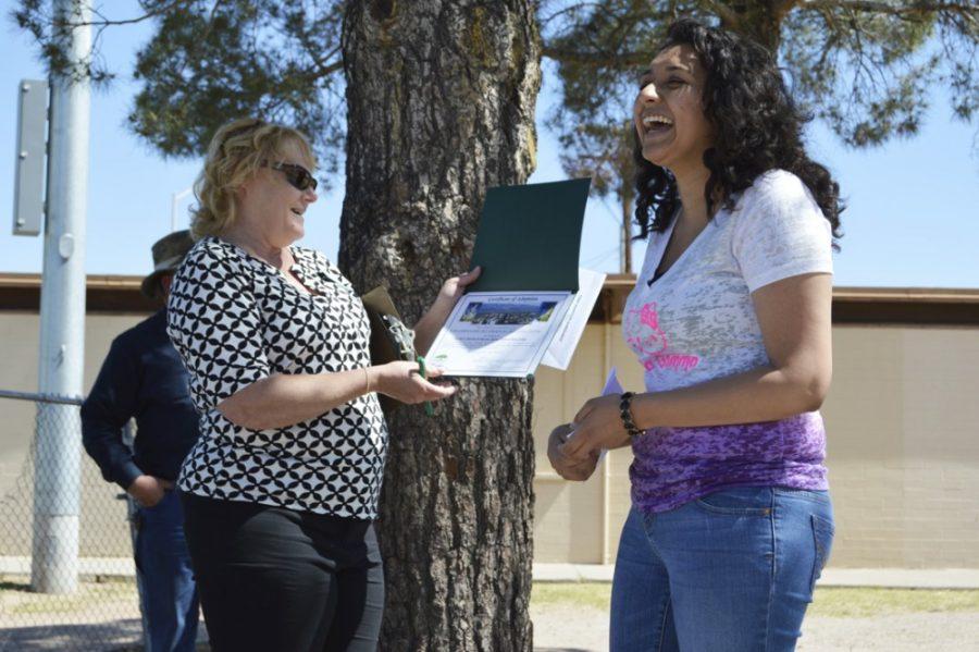 Jean Hickman, Adopt-a-Park coordinator for Tucson Clean & Beautiful, presents Connie Lira a certificate signed by representatives from Tucson Clean and Beautiful and city of Tucson Parks and Recreation at the David G. Herrera and Roman Quiroz Park at the Oury Center on Saturday. Lira is the community service chair for Sigma Lambda Gamma National Sorority Inc., and the ceremony was held to recognize the ongoing commitment of the sorority members.
