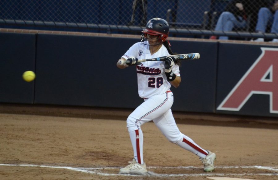 Arizona softball utility player Ashleigh Hughes (28) attempts a bunt during Arizonas 11-0 victory over Stanford on Friday at Hillenbrand Stadium. Along with Alexis Dotson, Hughes provided valuable offense for the Wildcats over the weekend.