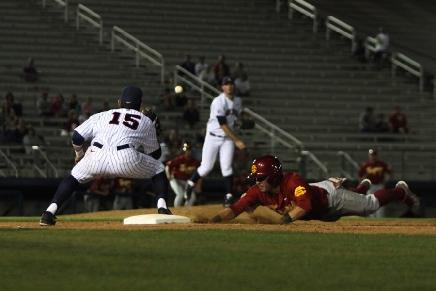 Arizona baseball outfielder Joseph Maggi (15) sets up to receive a toss back to the bag as a USC Trojan slides back to first base during Arizonas 4-1 loss to USC at Hi Corbett Field on April 2. Maggi and the Wildcats take on ASU in a rare nonconference game between the rivals today.