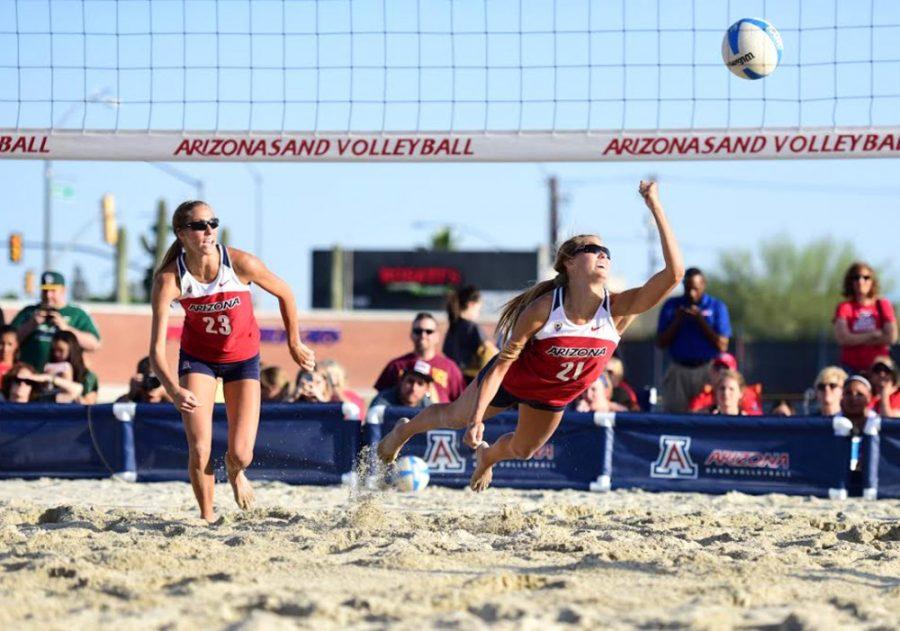 Arizona sand volleyball player McKenna Witt (21) dives for a volley while Madison Witt (23) looks on during Arizonas 4-1 victory over Arizona State on Wednesday at Jimenez Field. The Wildcats closed their home portion of the season with a 8-1 record.