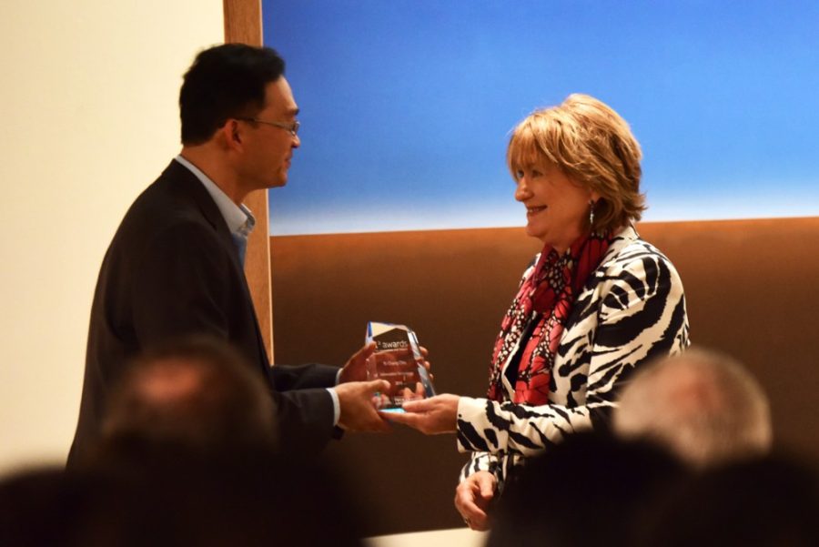 Yi-Chang Chiu, founder of the Metropia app, accepts the information technology award from President Ann Weaver Hart in the UA Museum of Art during the I-Squared Awards for Innovation and Impact on Thursday. Other awards were given based on their improvement of quality of life through research and innovation.