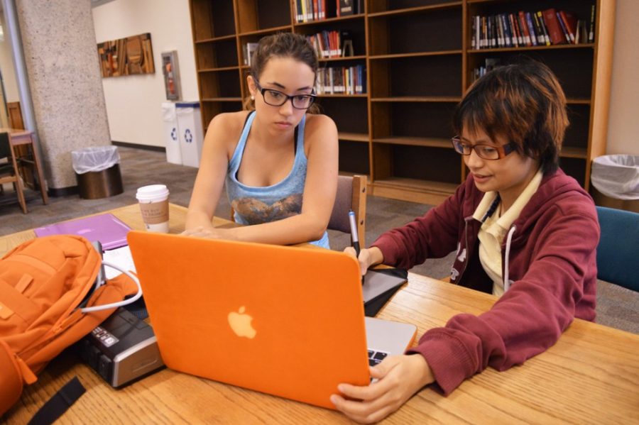 Students study together for final exams in the UA Main Library on Thursday. Finals Survival Week will continue today with yoga, back rubs, therapy dogs, fresh fruit, ice cream and giveaways beginning at noon on the UA Mall.