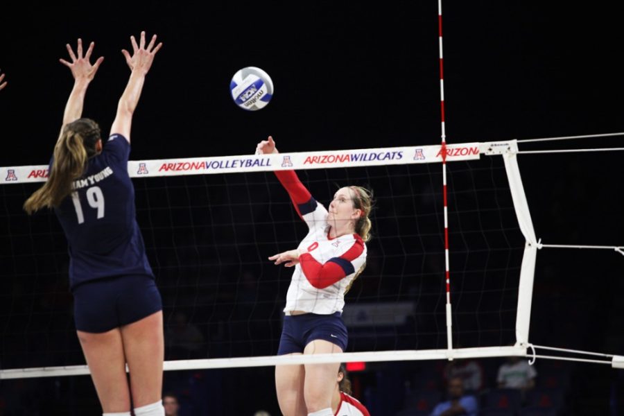 Arizona+volleyball+outside+hitter+Madi+Kingdon+%289%29+spikes+the+ball+past+BYU+opposite+hitter+Jennifer+Hamson+%2819%29+during+Arizonas+close+3-1+loss+to+BYU+in+the+second+round+of+the+NCAA+Division+I+Champsionship+Tournament+in+McKale+Center+on+Dec.+5%2C+2014.+Kingdon+led+both+the+indoor+and+sand+volleyball+teams+to+impressive+records.