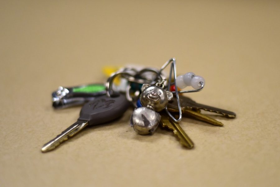 A beaten-up teddy bear keychain lies on top of a set of keys. Mr Bear has been through four years of hard work and crazy adventures and has had many at-home repairs to make it to graduation.