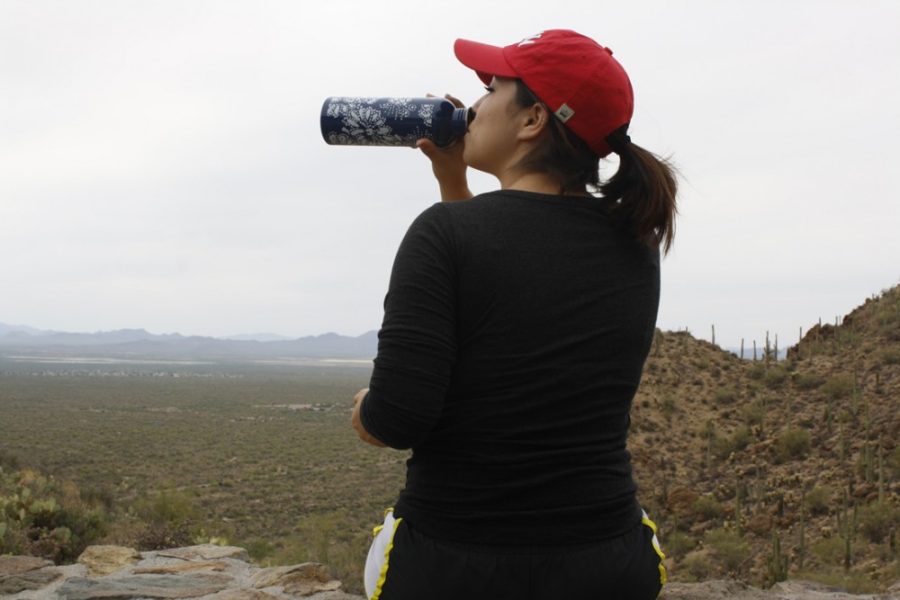 Baraha Elkhalil / Arizona Summer WildcatUndeclared junior Anysa Rangel drinks water at Gates Pass on Monday afternoon. Gates Pass is a popular destination to observe the vivid oranges, yellows, pinks and purples of Arizona sunsets. 