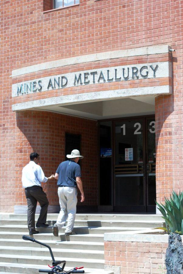 <p>Two people walk into the Mines and Metallurgy building on the University of Arizona campus on Tuesday, August 25, 2015. The Department of Mining and Geological Engineering, located in the building, is a part of the College of Engineering.</p>