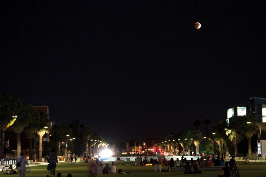 The eclipsed supermoon rises over the UA Mall on Sunday, Sept. 27. The next date of a simultaneous eclipse and supermoon — the moon when it is at its closest point in its orbit to the Earth — is 2033.