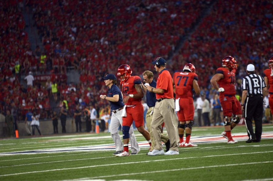 <p>Arizona quarterback Anu Solomon (12) walks off the field after receiving an injury during a game against UCLA at Arizona Stadium on Saturday, Sept. 26.</p>