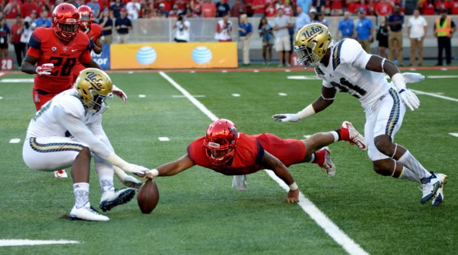 Arizona quarterback Anu Solomon (12) attempts to recover a fumble during the Wildcats loss to UCLA at Arizona Stadium on Saturday, Sept. 26. Solomon suffered a concussion in the loss and might be unable to play Saturday against Stanford. 