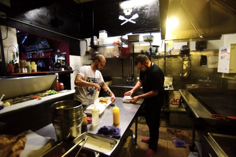 Lead day cook Mike Barber, left, and line cook Richard Valdez, right, package up two hamburgers of the month and a Super Sunrise in the kitchen at Lindy’s on 4th at 431 N. 4th Ave. on Thursday, Sept. 3. Lindy’s is one of Tucson’s favorite casual hamburger joints.