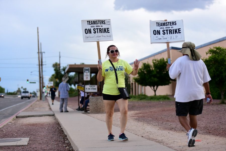 Sun Tran employees on strike with Teamsters Local Union 104 walk the 4400 block of Park Avenue outside of Tucson City Council Ward 5 office on Monday, Aug. 31, 2015. 

Photo by: Rebecca Noble / The Daily Wildcat