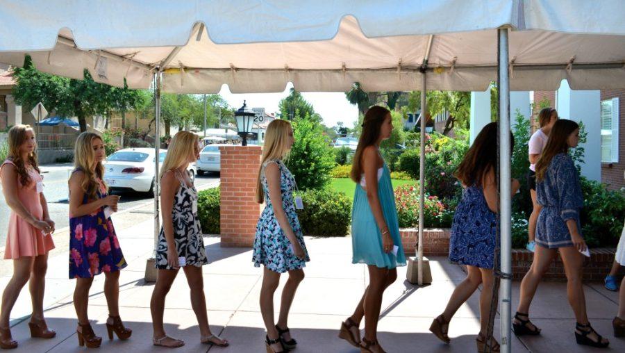 Potential new members line up outside of Chi Omega sorority on Thursday, Aug. 20, 2015. The formal recruitment process includes entering sorority houses while recruitment counselors dance beside prospective members. 