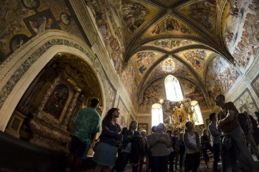 Visitors gaze at frescos inside the Duomo di Orvieto in Orvieto, Italy on Wednesday, May 27, 2015. The church draws visitors from across the globe. (Photograph by Alex McIntyre)