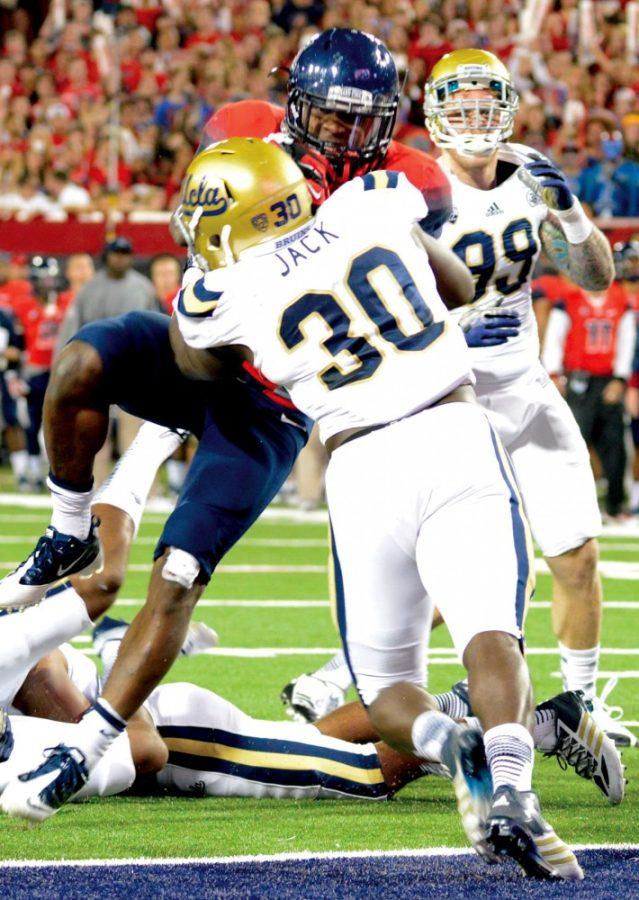 UCLA linebacker Myles Jack (30) stops the Wildcats just before the endzone at Arizona Stadium on Saturday, Nov. 9, 2013. Jack kicked off what has been a whirlwind month for college football by withdrawing from UCLA following a season-ending injury.