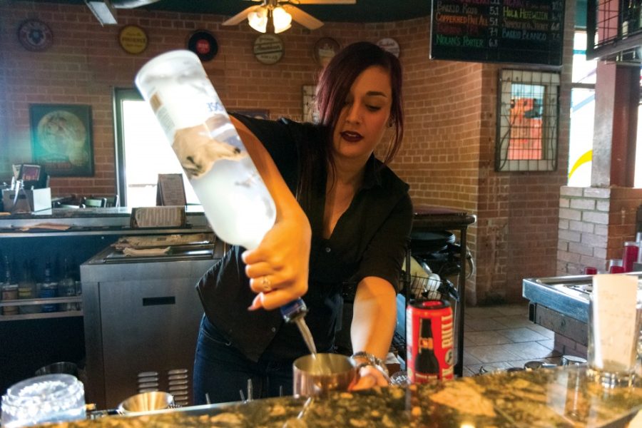 Lauren Galhotra, bartender at Gentle Ben’s Brewing Company, prepares a drink for a customer on Wed., Oct. 7. Gentle Ben’s is located at 865 E. University Blvd.