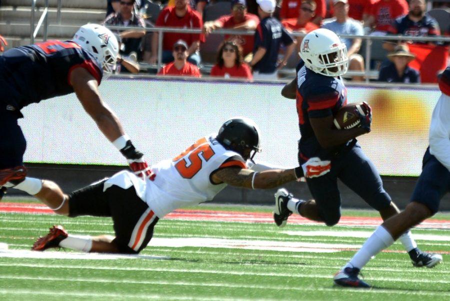 <p>Arizona running back Nick Wilson (28) dodges a tackle by Oregon State's Caleb Saulo (35) at Arizona Stadium on Saturday, Oct. 10. Wilson leads the Wildcats' rushing attack with 683 yards and eight touchdowns.</p>