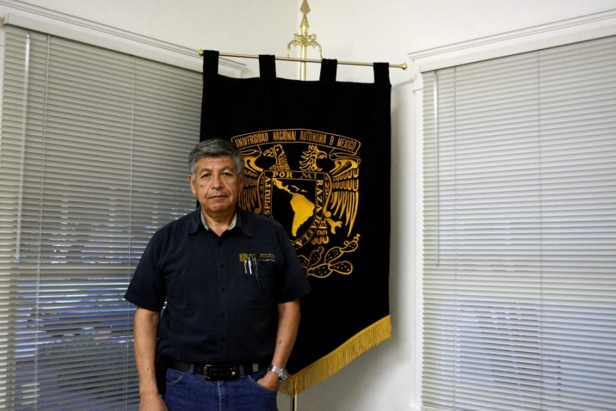 Arnoldo Bautista, the relations and management secretary for Centro de Estudios Mexicanos – Tucson, stands with the Universidad Nacional Autonoma de Mexico flag for a photo in the new Center for Mexican Studies building on the UA campus Monday, Oct. 5. The new center is part of UNAMs mission to strengthen ties with host universities in the U.S. and other countries.