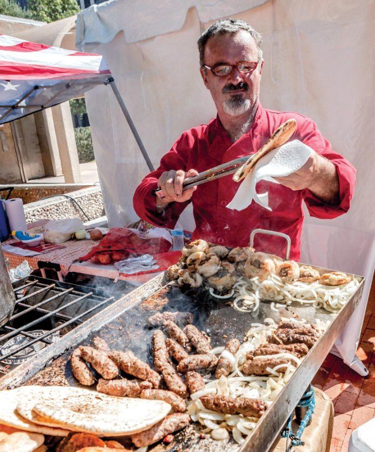 Courtesy of Maribel AlvarezA vendor at Tucson Meet Yourself prepares Bosnian cuisine at his booth at the 2014 event. The festival is held annually and gives the community a chance to experience different cultures.