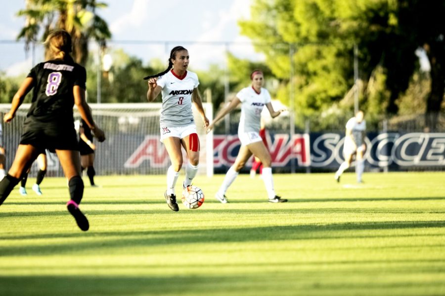 <p>Midfielder Gabi Stoian (9) takes the ball downfield toward the opposition's goal. Stoian made 13 goals last season, and her score is tied for the second-best total in UA history.</p>
