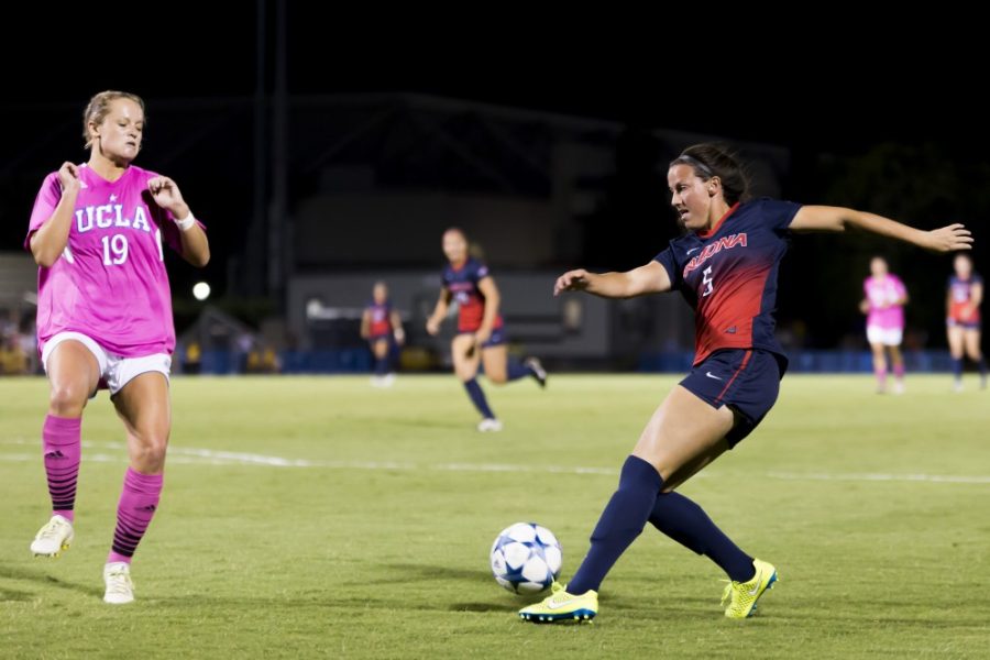 <p>Aubrey Yeo / Daily Bruin</p><p>Arizona forward Kaitlyn Lopez (5) maneuvers the ball around UCLA defender Madison Tye (19) during the Wildcats' loss Friday, Oct. 9. The Wildcats were swept by both UCLA and USC by a goal differential of 8-2. </p>